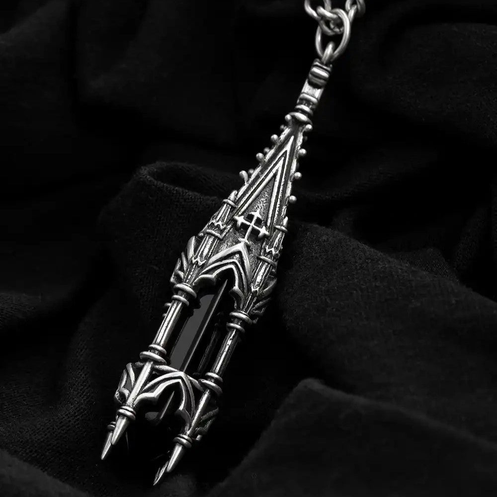 Restyle gothic cathedral tower pendant close-up view with black glass crystal in sculpted architectural setting.