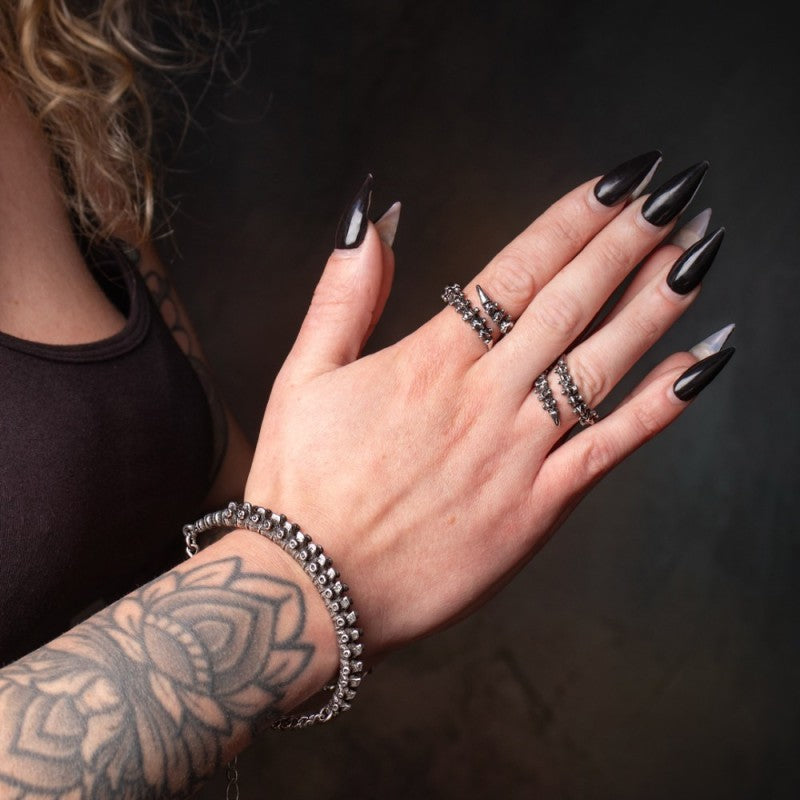 Alchemy Gothic A148 pewter spine bracelet front view on a wrist combined with matching spine rings.