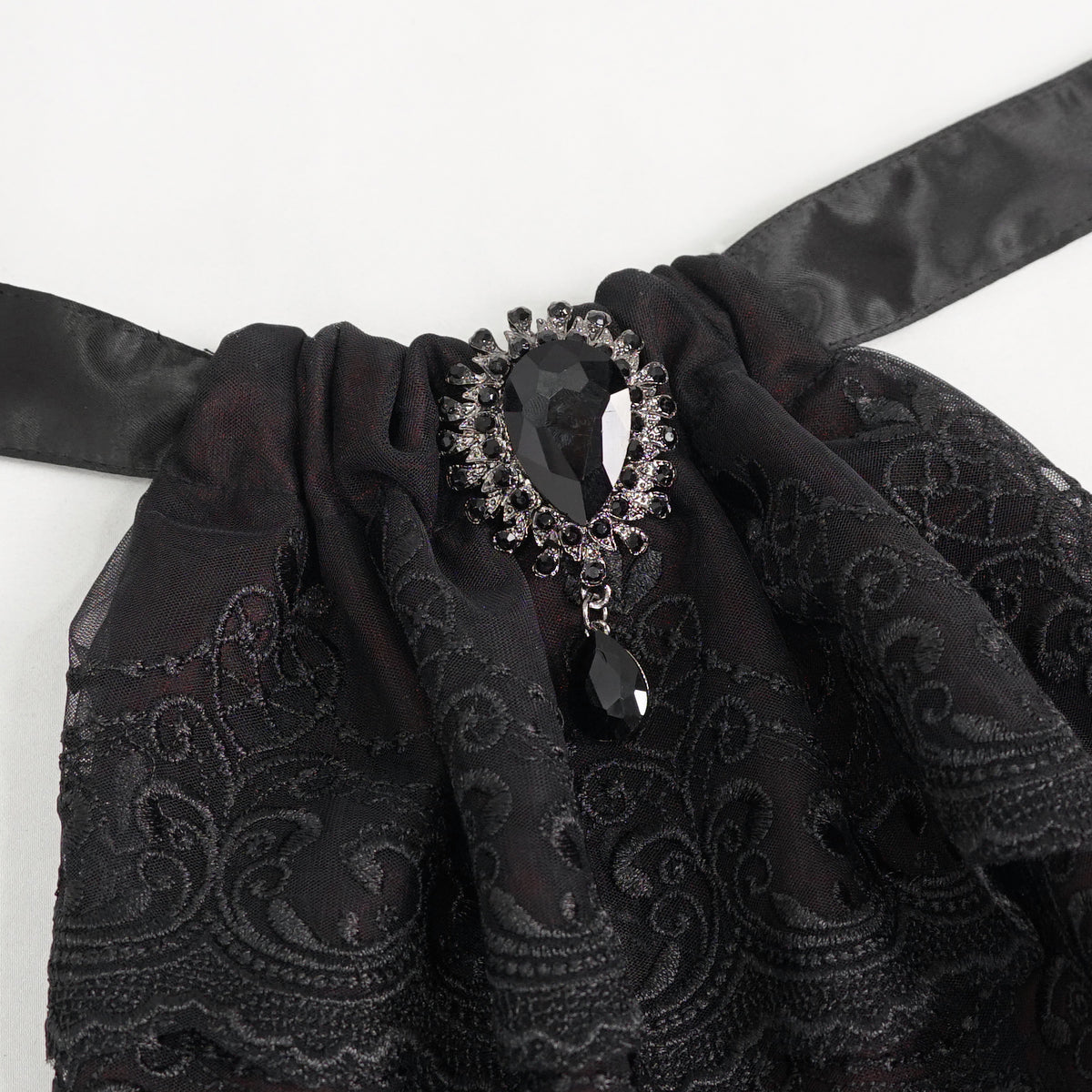 Devil Fashion AS144 burgundy black gothic jabot close-up focusing on the oval metal frame with black stone.