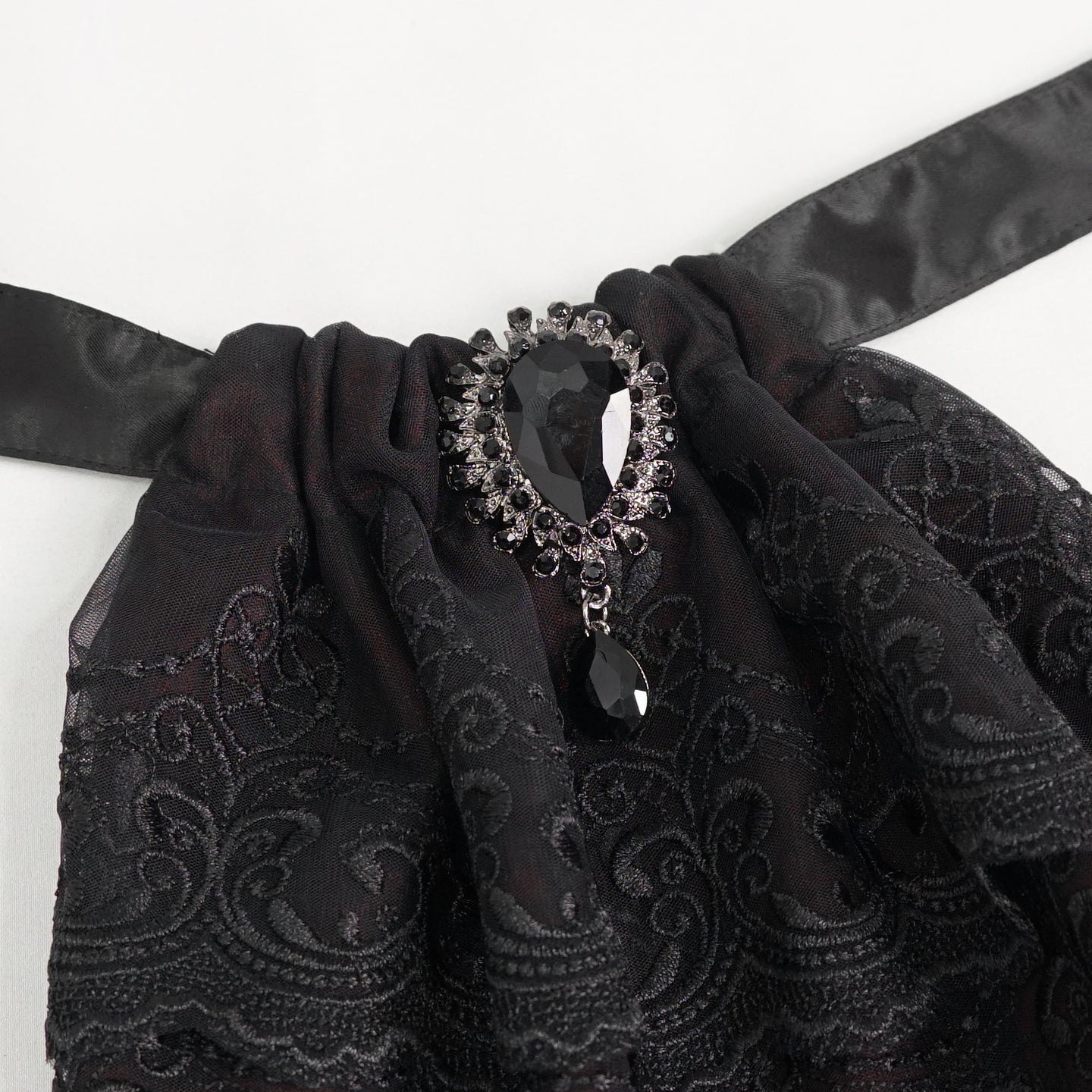 Devil Fashion AS144 burgundy black gothic jabot close-up focusing on the oval metal frame with black stone.