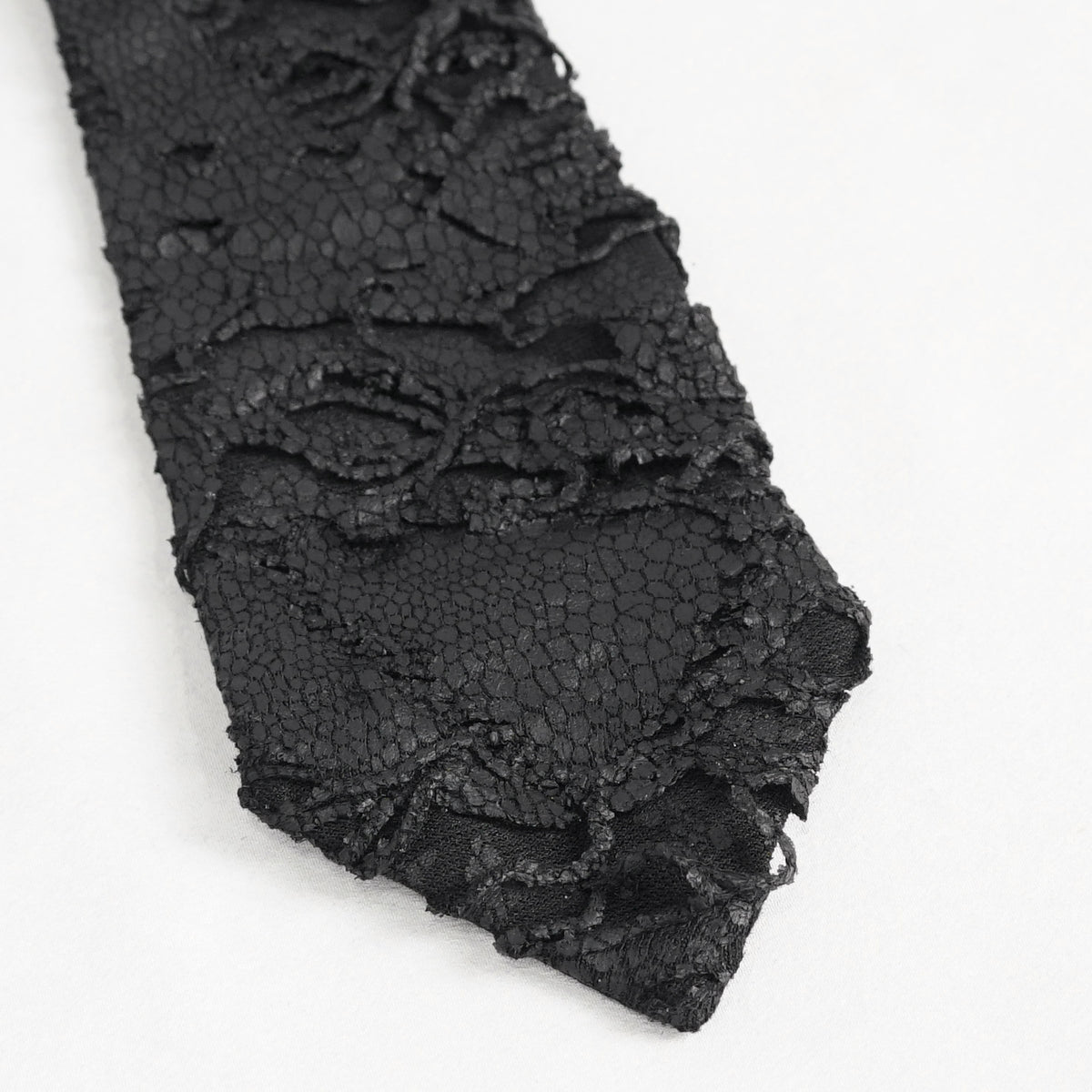 Devil Fashion AS148 womens black dark punk tie close-up showing the coated fabric with worn scale pattern.