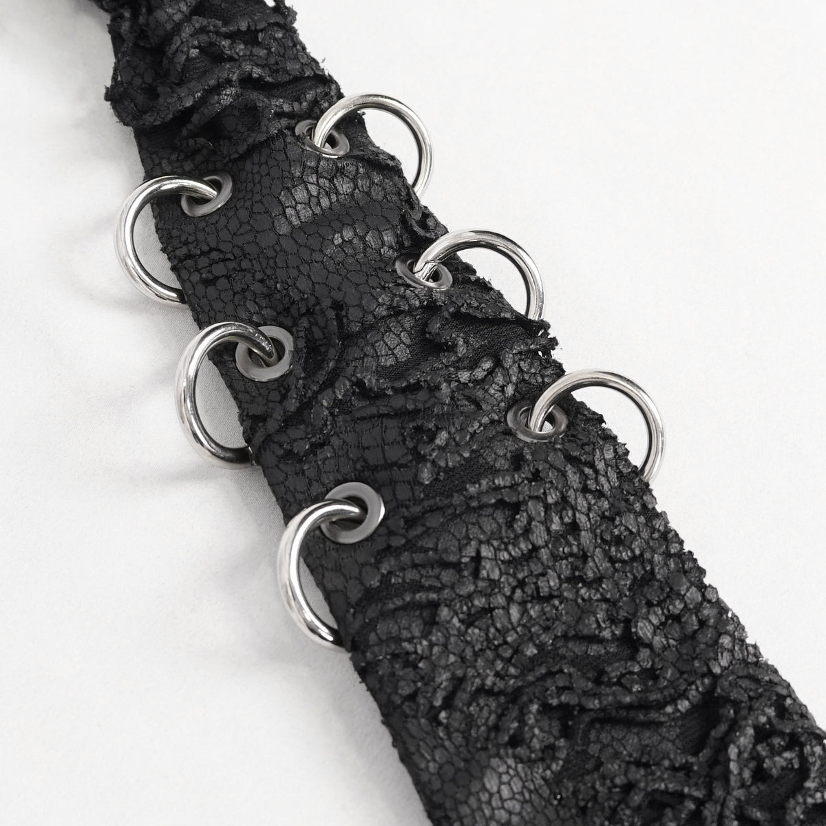 Devil Fashion AS148 womens black dark punk tie close-up focusing on the silver metal O-rings decoration.