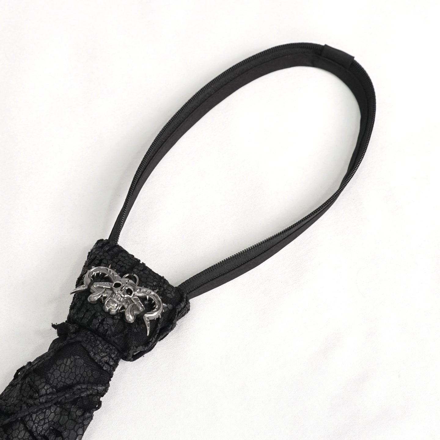 Devil Fashion AS157 mens black dark punk tie close-up focusing on the silver metal devil skull ornament.
