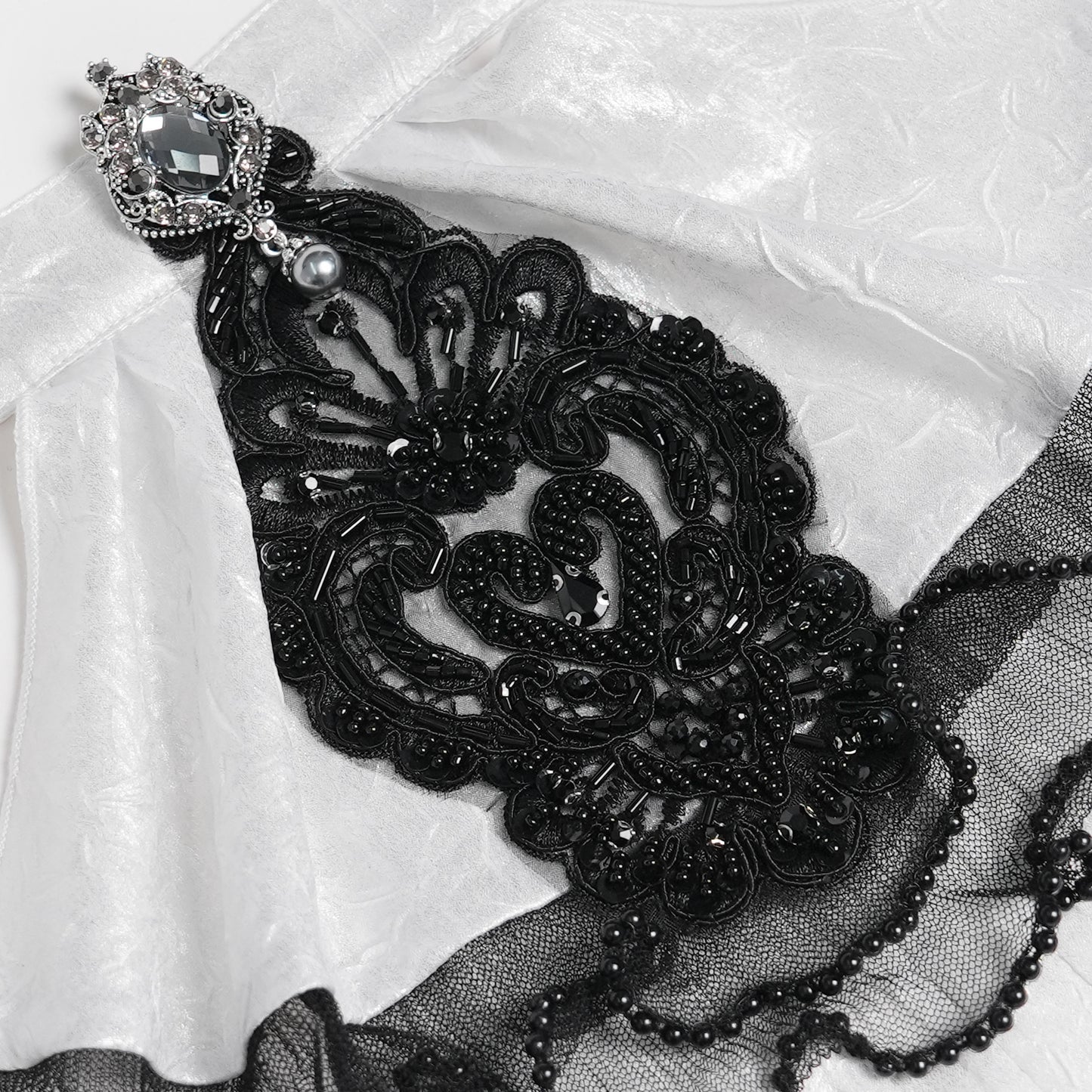 Devil Fashion AS28802 womens white and black Romantic jabot focusing on a central bead applique detail.