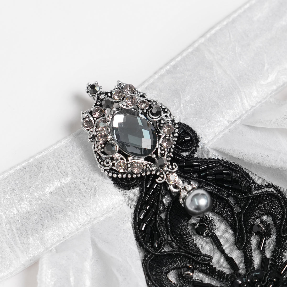 Devil Fashion AS28802 womens white and black Victorian jabot focusing on a metal brooch with a large crystal stone.