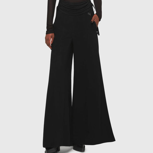 Kihilist Deteriorate women's gothic and dark casual pants in black showing a front view with wide legs.