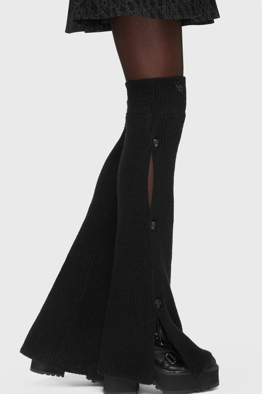 Kihilist Deadly Visions leg warmers showing a side view in black ribbed knit with metal skull buttons.