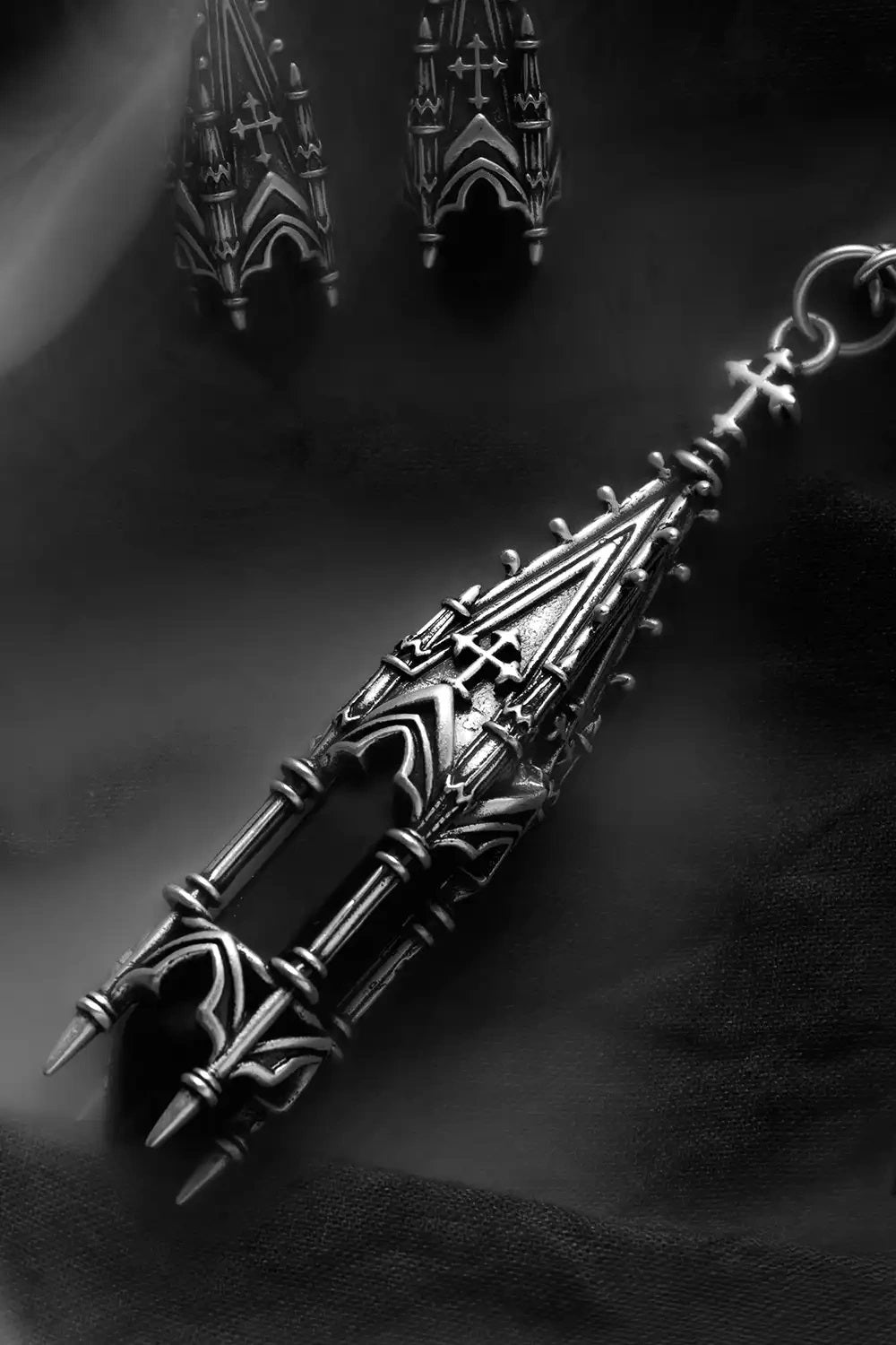 Restyle gothic cathedral tower pendant close-up view with detailed silver plated architectural motifs.